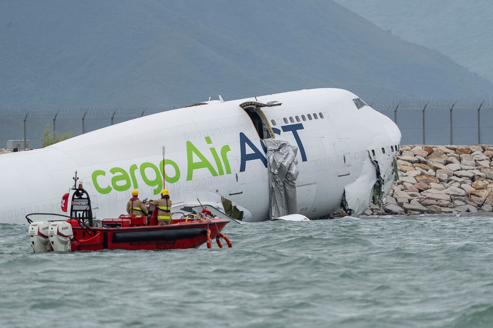 Cargo aircraft skids off Hong Kong runway into sea, killing 2 people